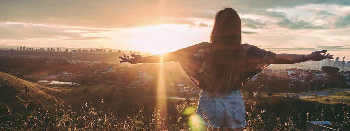 Woman in front of sunset