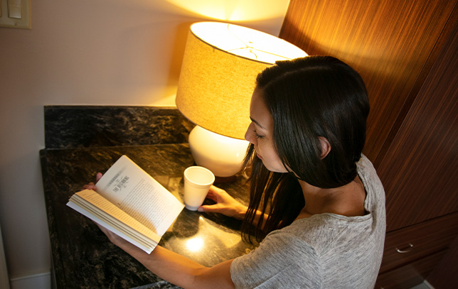 patient reading a book at a desk