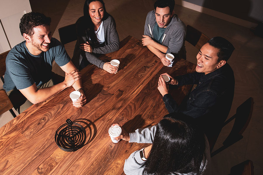 group of young adults chatting at the dining table after completing detox treatment for heroin