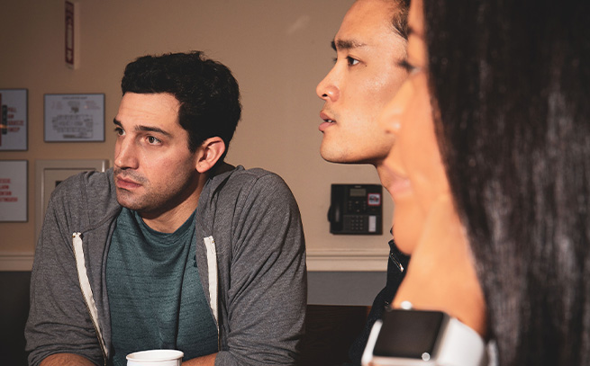 three people talking at a table at Sunrise Detox Center